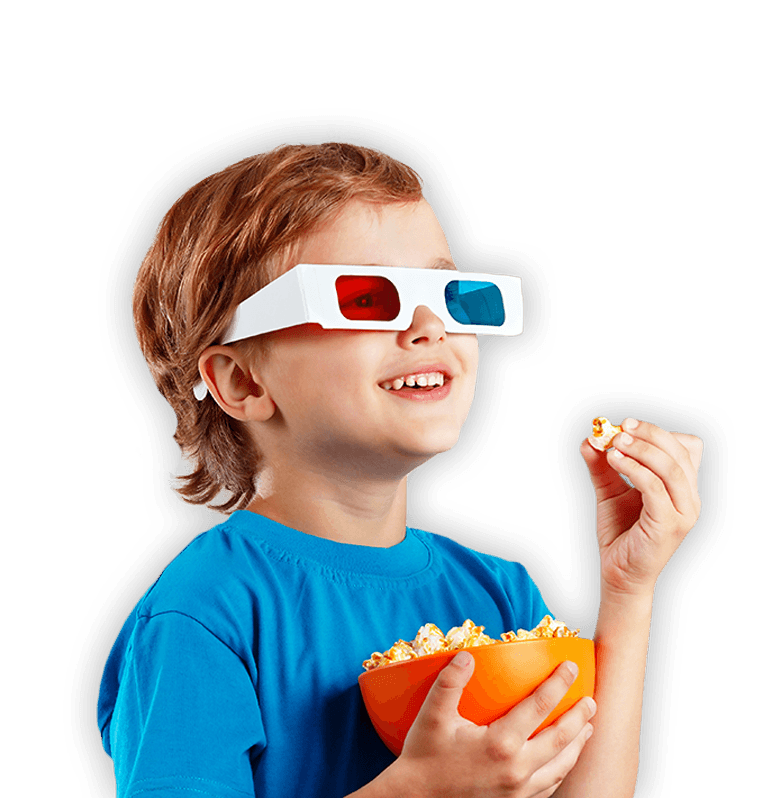 Child with 3D glasses eating popcorn