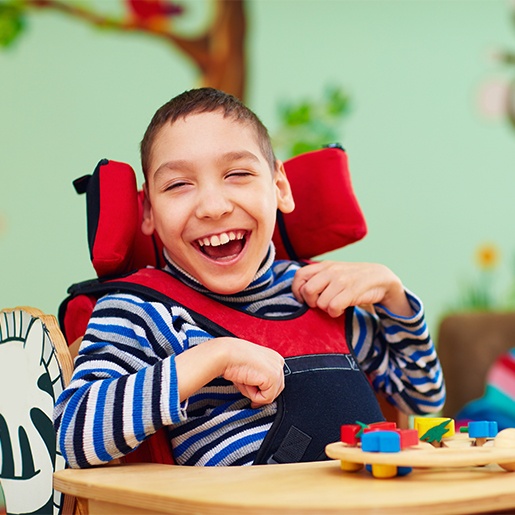 Laughing child in wheelchair